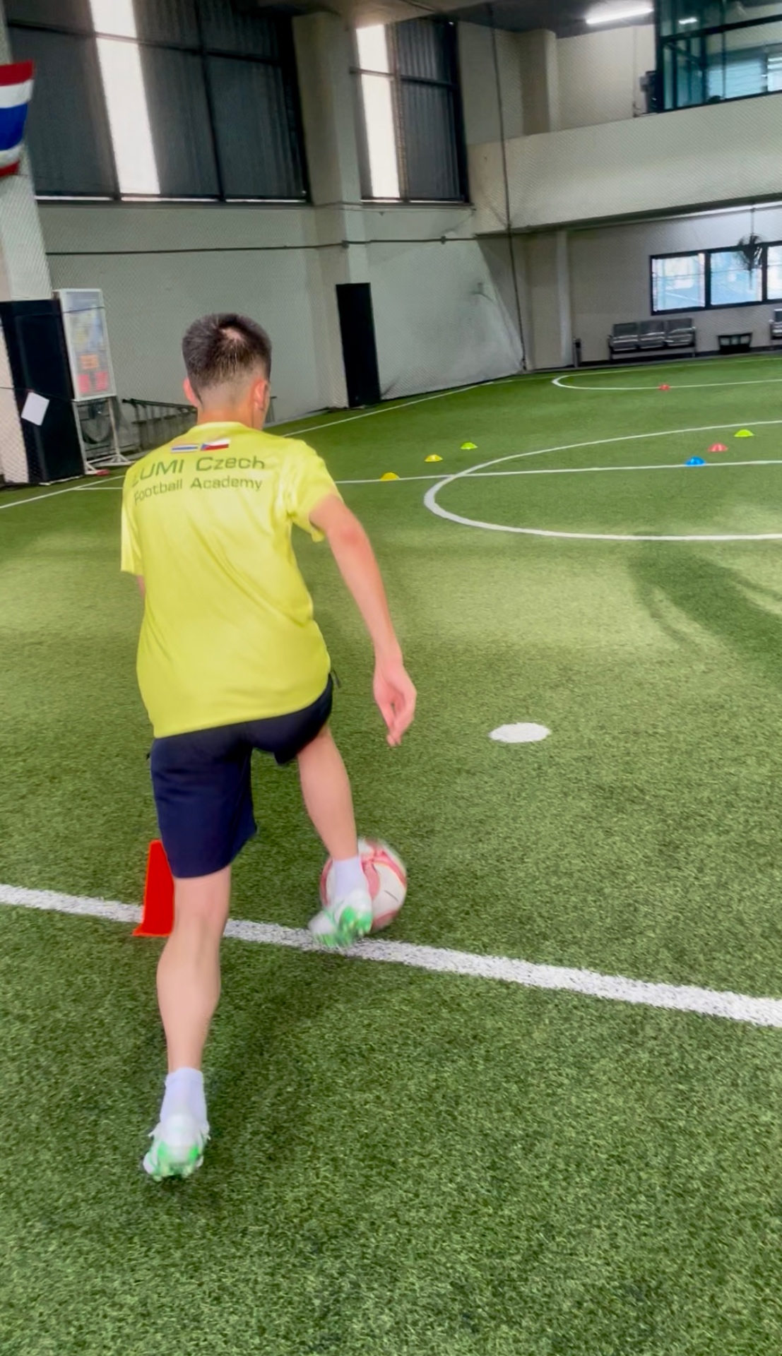 LUMI player training with the ball on an indoor pitch